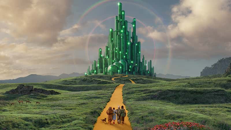 Dorothy and her friends journey along the Yellow Brick Road in a vibrant scene from The Wizard of Oz.